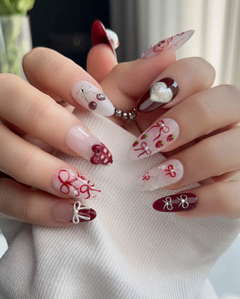 KT Cake press-on nails in M medium almond with playful dessert nail art and glossy gel finish