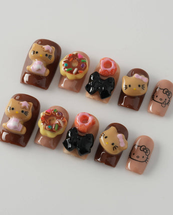 Close-up of Cocoa Kitty Brown Color nails with chocolate brown 3D dessert details