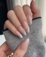 Your Glow press-on nails with glossy nude French styling and soft cat-eye shimmer