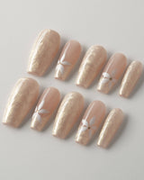 Spiral Twist nails with soft pearl nude base, silk texture, and glossy daisy accents