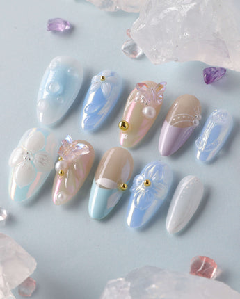 Aqua Petal close-up of glossy pastel blue nails with 3D flowers and butterfly detail