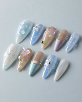 Aqua Petal reusable press-on nails with dreamy flowers, butterflies, and soft blue glow