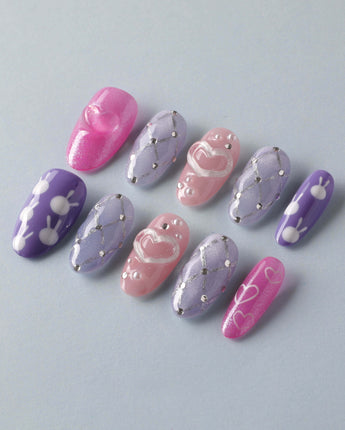 Charming Glam Usagi medium oval nails with glossy handmade finish and charming accents