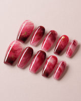 Gone with the Wind press-on nails with marbled burgundy and gold foil accents