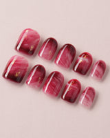 Gone with the Wind press-on nails with marbled burgundy and gold foil accents