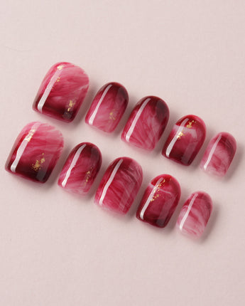 Gone with the Wind press-on nails with marbled burgundy and gold foil accents