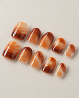 Onyx Shine nails with caramel amber marble color and dark glossy dimension
