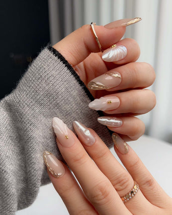 Venus close-up of 3D shell nail art on pearly nude gel polish