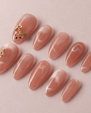 Thump Bunny close-up of peach heart cat-eye nails with glossy bunny detail