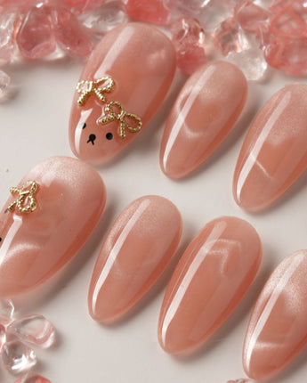 Thump Bunny medium oval press-on nails with peach heart cat-eye and bunny feature