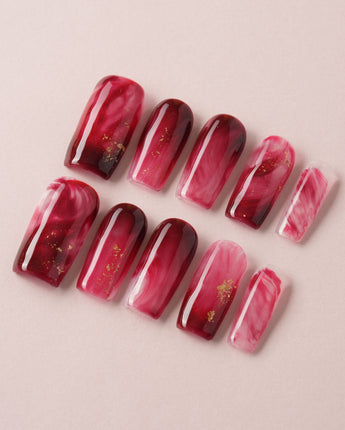Gone with the Wind press-on nails with marbled burgundy and gold foil accents