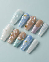 Aqua Petal soft blue press-on nails with sculpted floral accents and pearly finish