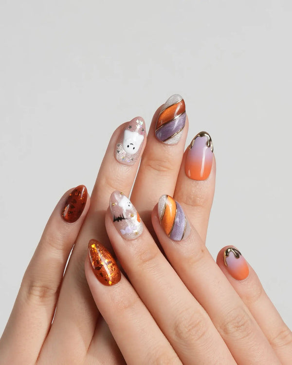 Cute Halloween nails with ghost and pumpkin accents