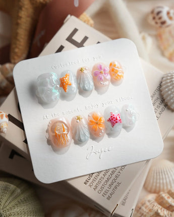 Tangerine Dream close-up of coral sunset nail art with 3D ocean details