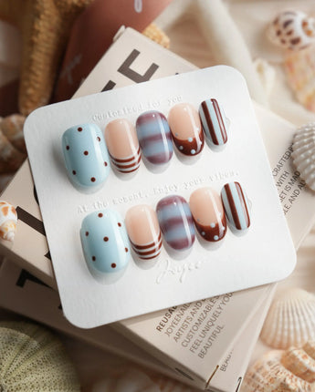 Cocoa Dot brown polka dot press-on nails with baby blue and marble accents