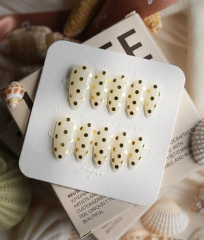 Golden Dot metallic gold dot nails with mirror-like circles on a glossy nude base
