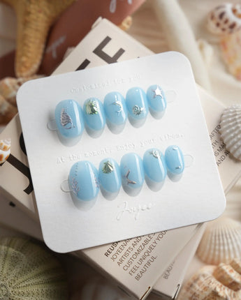 Sea Chrome metallic ocean press-on nails with sculpted fish, shell charms, and coral texture
