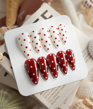 Creamy Cherry press-on nails with red and white polka dots with creamy cherry styling