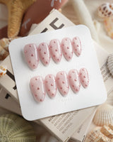 Rose Bead close-up of hand-placed metallic beads on soft pink gel polish