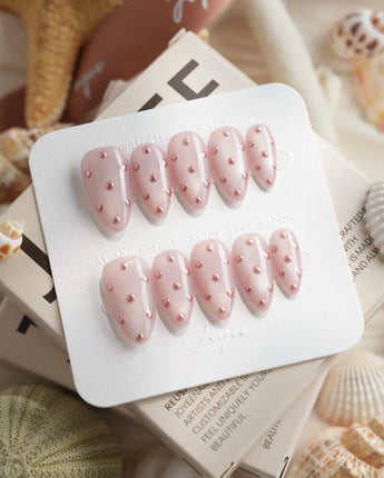 Rose Bead close-up of hand-placed metallic beads on soft pink gel polish