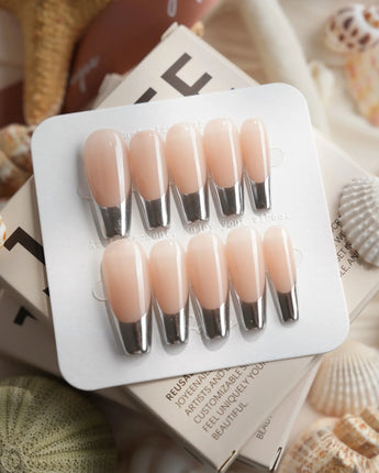 Silver Sleek silver chrome French nails photographed with high-shine reflective tips