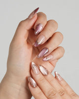 Caramel Petal press-on nails with glossy nude base, rose chrome tips and ornate gold accents
