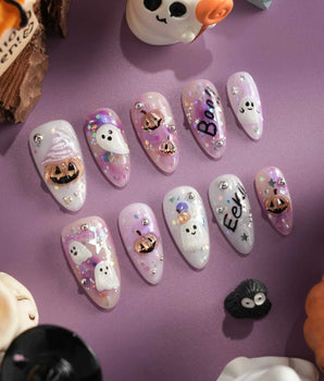 Hallow’s Eve handmade press-on nails featuring sheer pink base iridescent glitter ghost pumpkin 3D accents rhinestone mix
