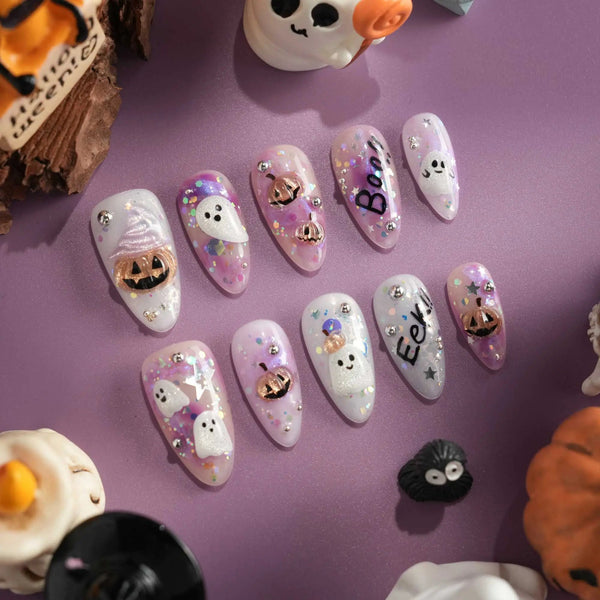 Hallow’s Eve handmade press-on nails featuring sheer pink base iridescent glitter ghost pumpkin 3D accents rhinestone mix