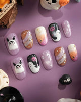Ghost Kuromi handmade press-on nails featuring sheer nude pink base orange gradient gold swirl ghost skull cartoon 3D