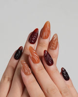 The Whole Fall nail set with warm amber tones, caramel gradient, and glossy ripple texture