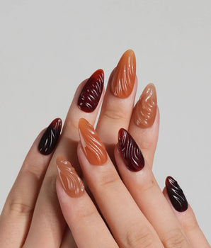 The Whole Fall nail set with warm amber tones, caramel gradient, and glossy ripple texture
