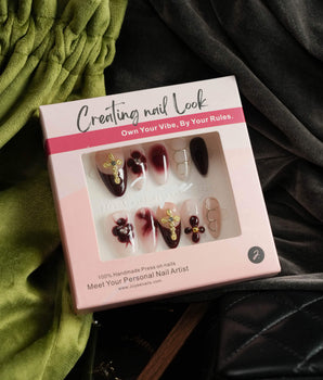 Tip Burgundy Nails press-on set with red French tips, gold cross charms, and floral details