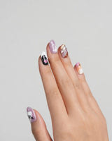 Ghost Kuromi nail art close-up showing sheer nude pink base orange gradient gold swirl ghost skull cartoon 3D details