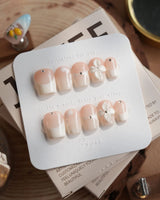 Ceramic press-on nails — Classic Nude Pink Ombré, 3D White Florals & Minimalist Rhinestones. handmade nail art by Joyee Nails
