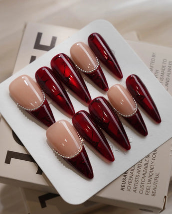 Brocade press-on nails with deep red rose print, carved texture and metallic bead details