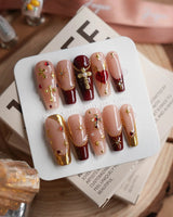 Gothic Red press-on nails with burgundy red, ornate gothic details and 3D metallic crosses