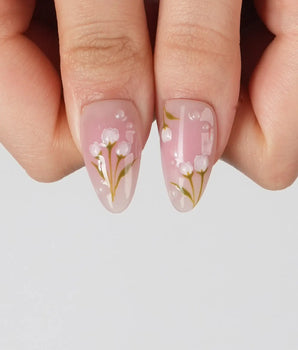 Coquette Garden handmade press-on nails featuring Gentle Pink Gradient, 3D White Bows & Hand-painted Tulips.