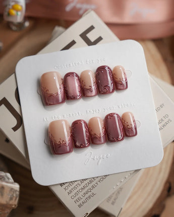 Rose Edge press-on nails with nude base, rose chrome tips and ornate baroque swirls