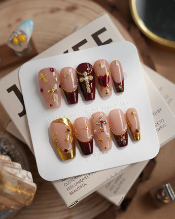 Gothic Red press-on nails with gothic metallic crosses, burgundy red accents and glossy finish