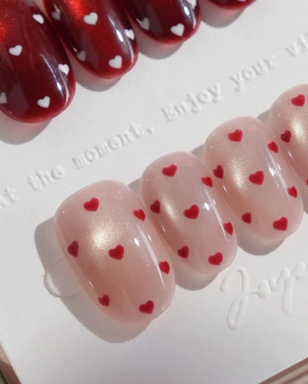 Heart Collector handmade press-on nails featuring Vintage Red Pear, Contrasting Red & White Hearts, Cat-eye Shimmer