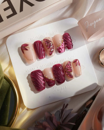 Velvet Flow press-on nails with sultry berry cat-eye shimmer and dimensional butterfly accents