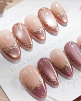 Caramel Petal press-on nails with rose chrome French tips, nude base and gold baroque details