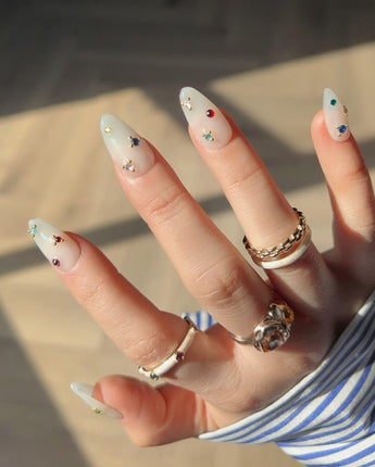 Sicily nails nail art close-up showing milky white colorful rhinestone nails details