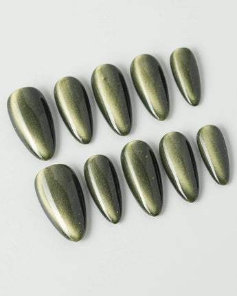 Alga press-on nails in medium almond shape — Deep Dark Green, Cat Eye Glossy Effect.