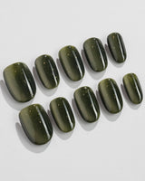 Alga press-on nails in short oval shape — Deep Dark Green, Cat Eye Glossy Effect.
