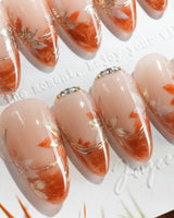 Amber Maple nail art close-up showing orange french tips gold outline maple leaves details