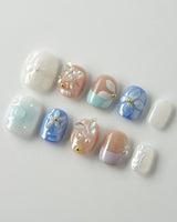 Aqua Petal extra short squoval nails with pearly pastel flowers and butterflies