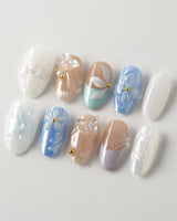 Aqua Petal medium oval nails with pearly pastel flowers and 3D butterfly accents