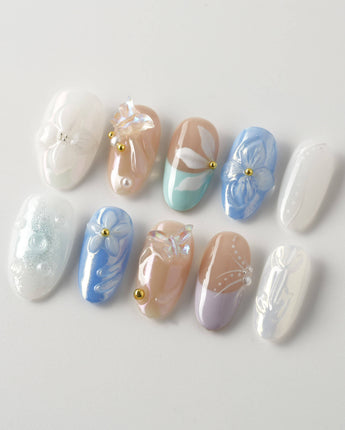 Aqua Petal medium oval nails with pearly pastel flowers and 3D butterfly accents
