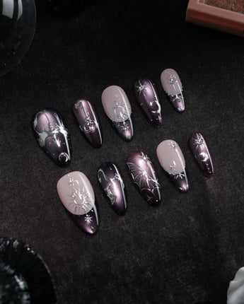 Arcana press on nails with sculpted silver sun, moon, star and key charms and a silver wing on plum and black cat eye with crystals - image 3